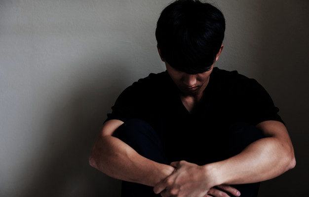 uomo asiatico depresso che si siede vicino alla parete 33842 134 626x400 1